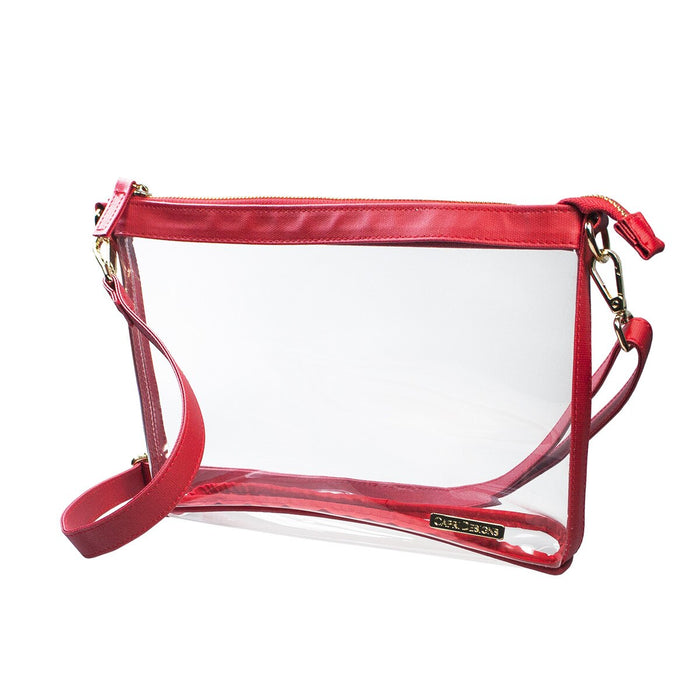 A clear plastic pouch bag with red leather trim, a red shoulder strap, and gold-tone hardware, shown on a plain white background.