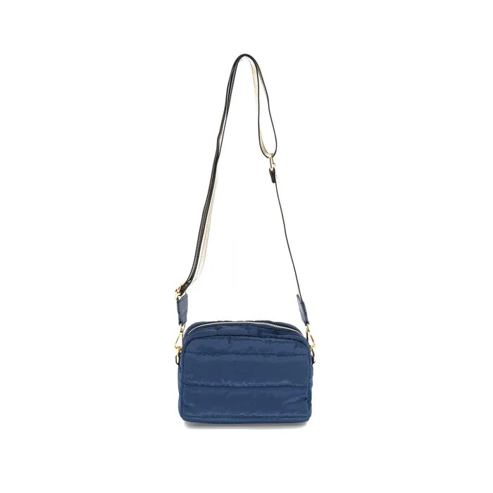 A navy nylon crossbody puffer bag with a removable strap and gold-tone hardware.