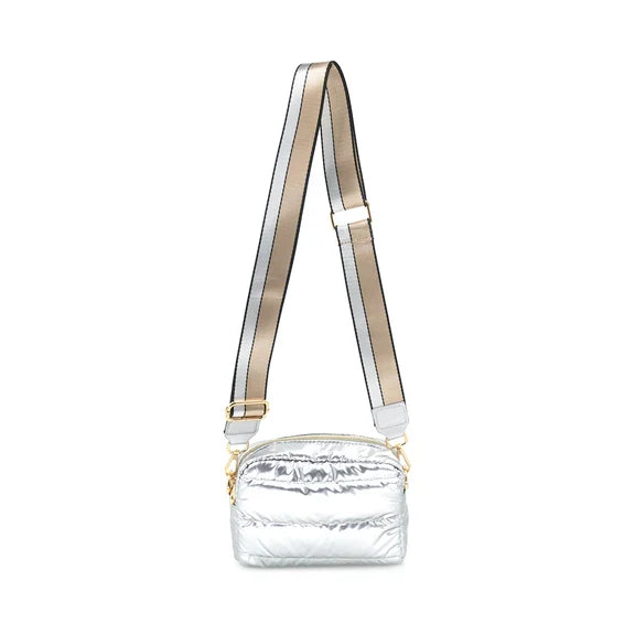 A silver nylon crossbody puffer bag with a removable strap and gold-tone hardware.