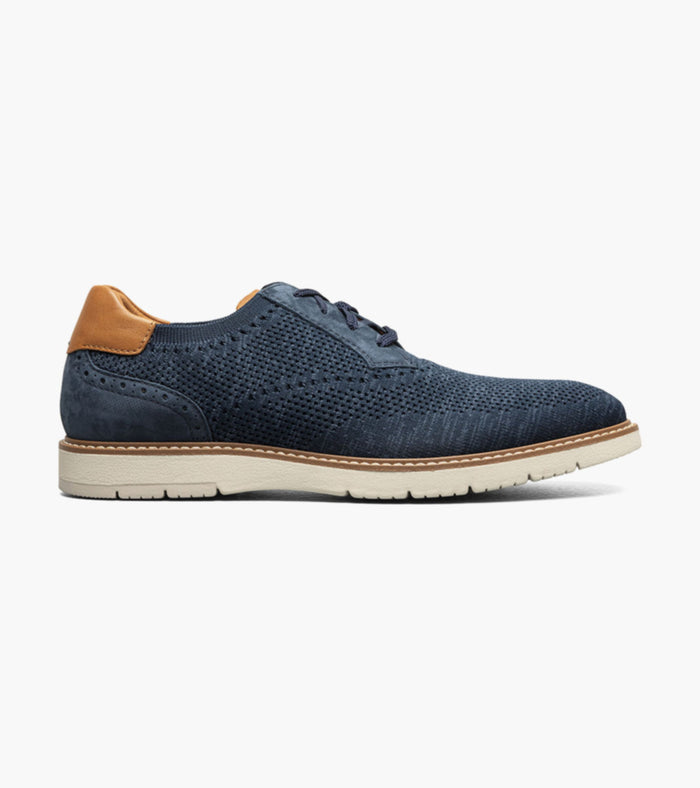 Blue shoe with brown heel on a white background