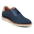A casual men's shoe with a navy blue knit textile upper and nubuck detailing, featuring a white rubber outsole and tan accents.