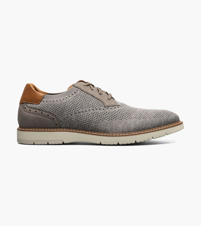 grey shoe with brown heel on a white background