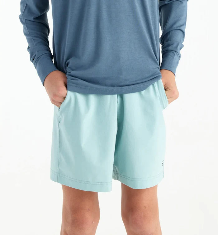 boy wearing a pair of aqua shorts