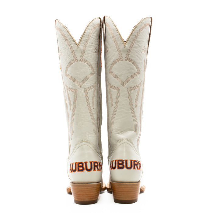A pair of white women's western boots with embroidered team logos and a wood heel, designed for gameday attire.