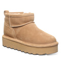 A brown suede youth boot with a layered EVA midsole and a wool blend lining, featuring a lightweight blown rubber outsole.