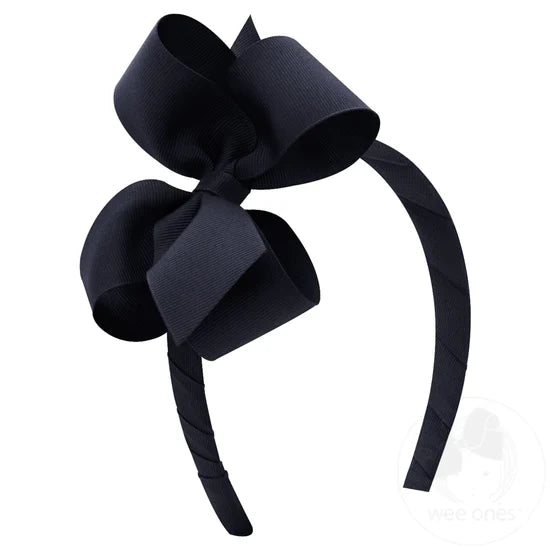 Navy bow and headband combo on a white background.