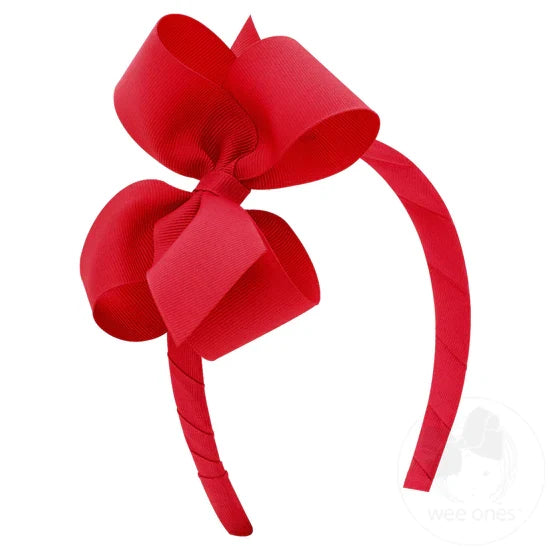 Red bow and headband combo on a white background.