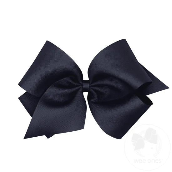 A large navy hair bow with a grosgrain ribbon and a knot in the center.