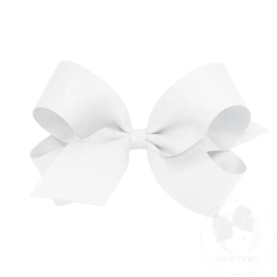 A large white grosgrain ribbon hair bow attached to a clip.