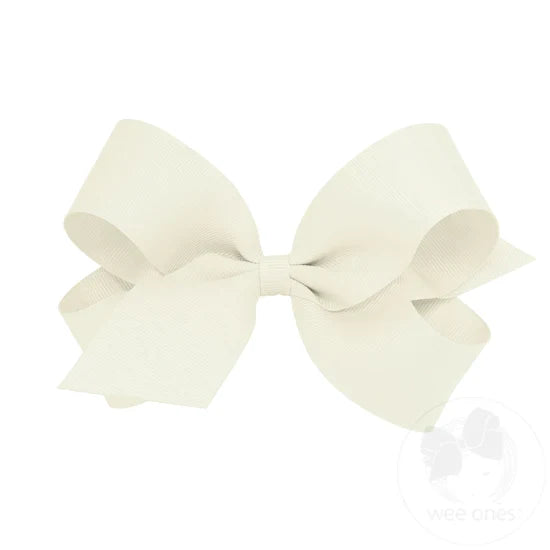 A large white grosgrain ribbon hair bow attached to a clip.