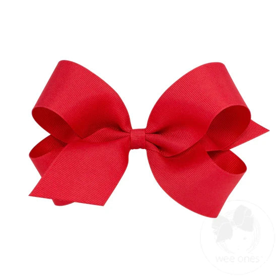 A red grosgrain ribbon hair bow attached to a clip.