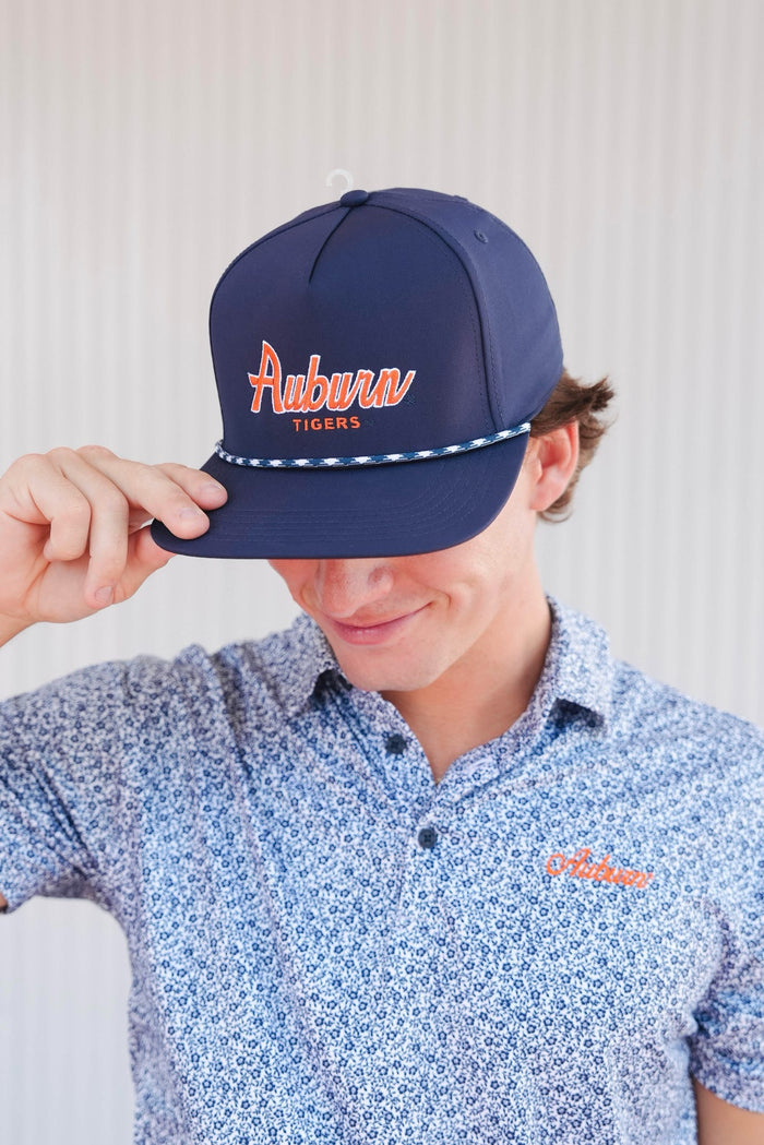 Person wearing a navy blue cap with 'Auburn Tigers' text, standing against a light background.