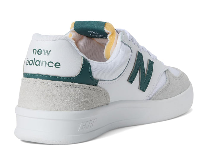 White New Balance sneaker with green accents on a white background