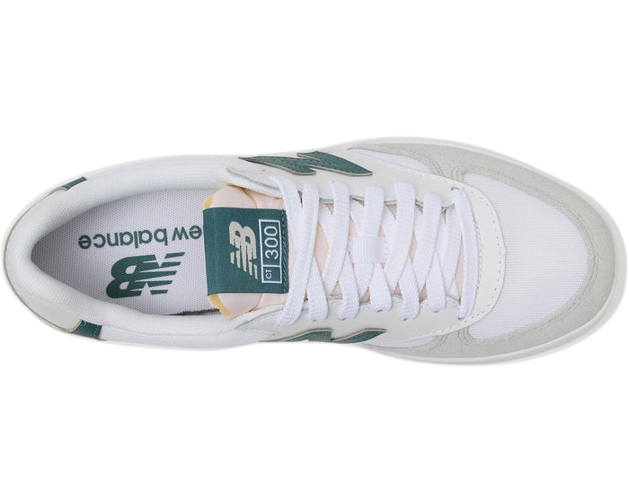 White sneaker with green accents and New Balance logo on a white background
