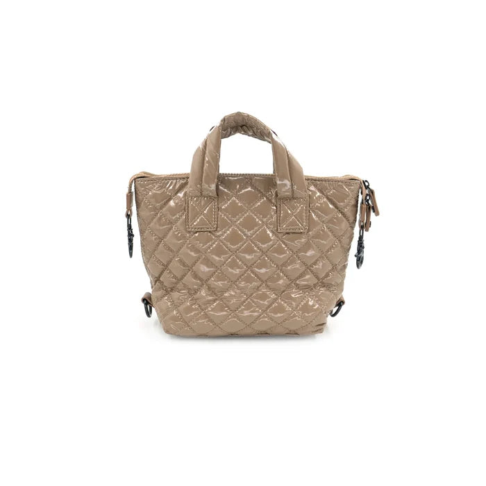 Glossy beige quilted handbag on a white background