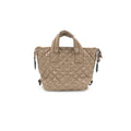 Glossy beige quilted handbag on a white background