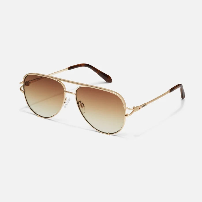 Gold-framed sunglasses with gradient lenses on a white background