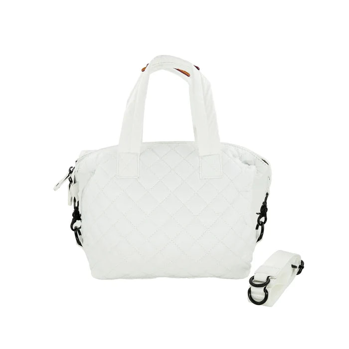 A quilted white crossbody bag with a removable strap, displayed against a plain background.