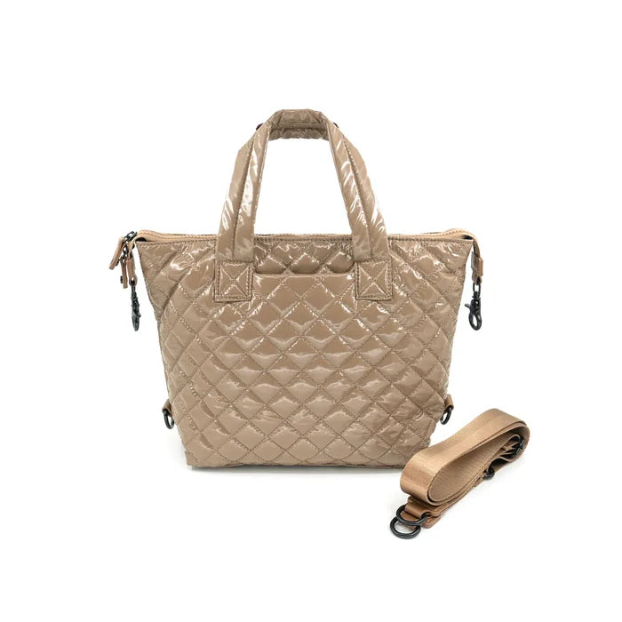 A quilted beige crossbody bag with a removable strap, displayed against a plain background.