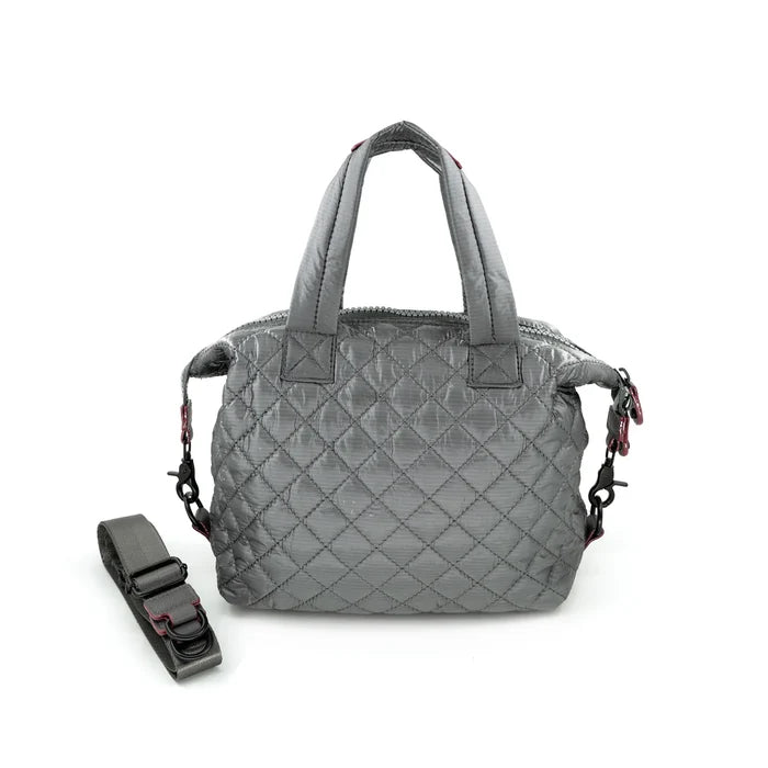 A quilted gray crossbody bag with a removable strap, displayed against a plain background.