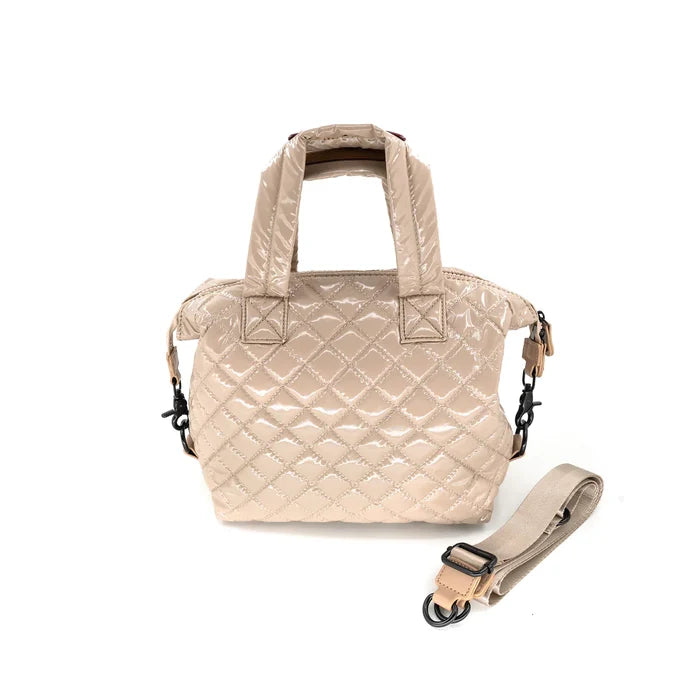 A quilted beige crossbody bag with a removable strap, displayed against a plain background.