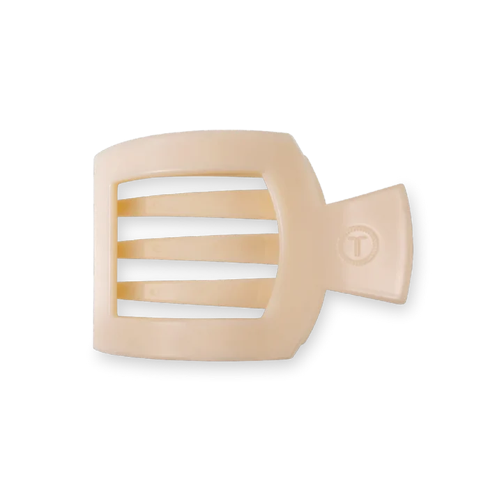 A beige flat square hair clip made of plastic.