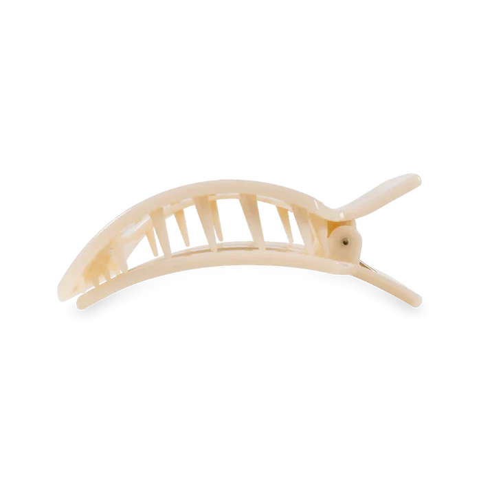 Beige flat open hair clip with large teeth to hold hair.