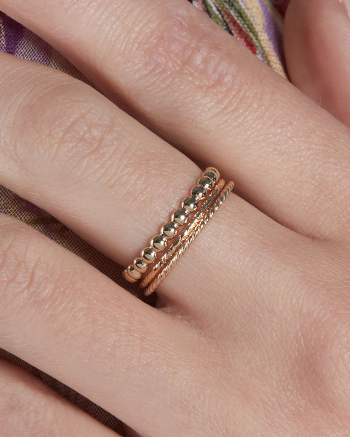 The Petite Etched Band is the ring in the middle of the stack