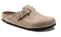 Beige clog shoe with a strap on a white background