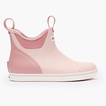 Pink rubber boot with white sole on a white background
