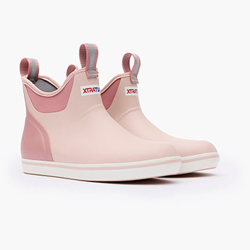 Pink rubber boot with white sole on a white background