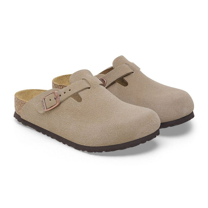 Beige clog shoe with a strap and buckle on a white background